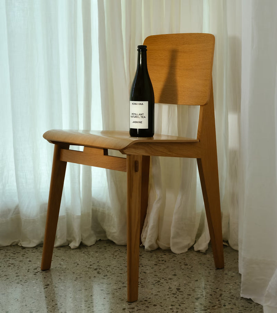 Wooden chair with Konanna Jasmine  on a white curtain background mood shot